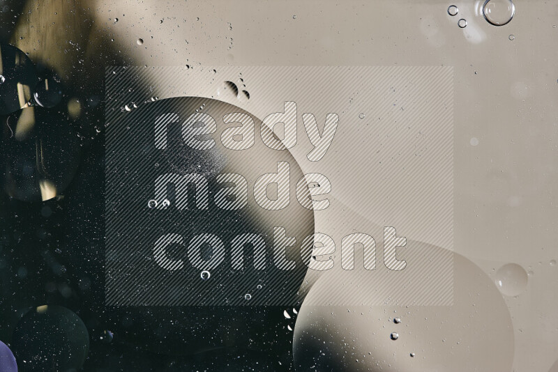 Close-ups of abstract oil bubbles on water surface in shades of green and brown