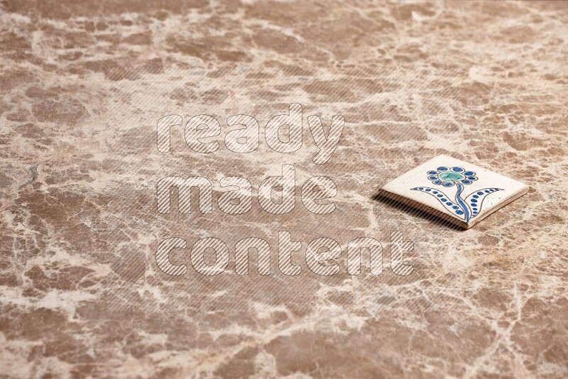 A decorative coaster on beige marble background