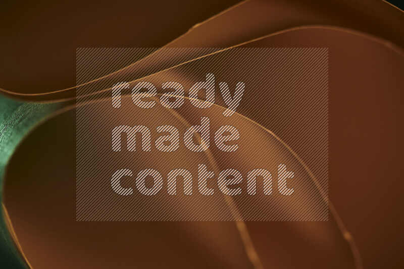 An abstract art piece displaying smooth curves in green and orange gradients created by colored light