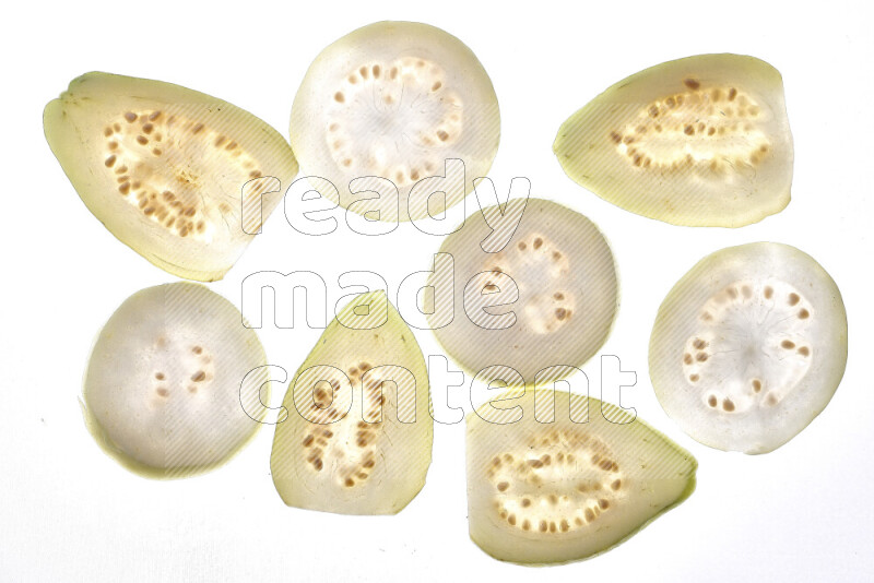 Guava slices on illuminated white background