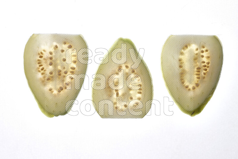 Guava slices on illuminated white background