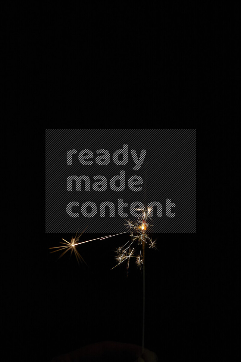 A close-up image of sparkler candle isolated on black background