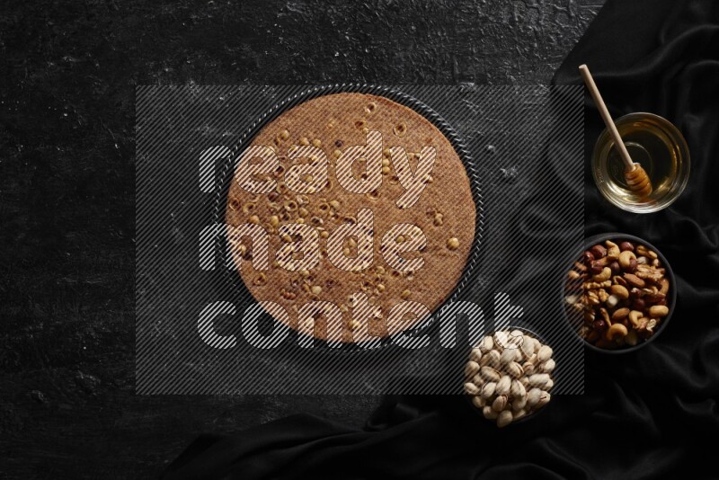 Basbousa with nuts and honey in a dark setup