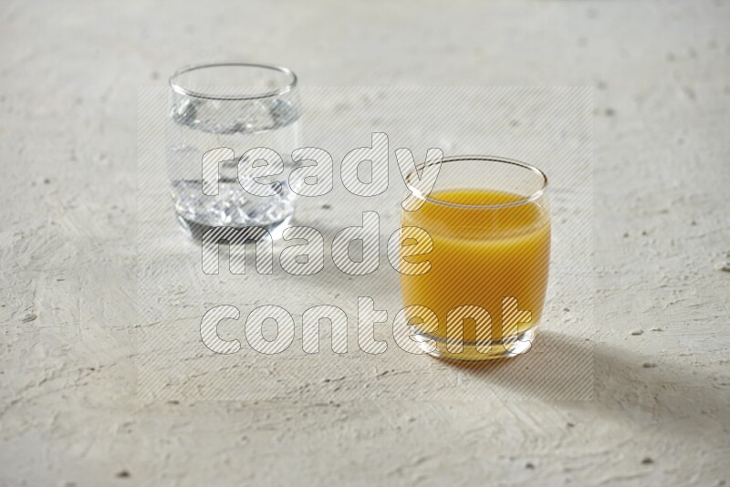 Cold drinks in a glass cup such as water, tamarind, qamar eldin, sobia, milk and hibiscus on textured white background