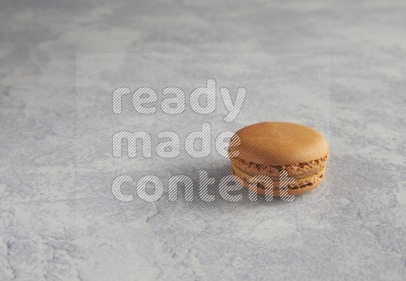 45º Shot of Brown Maple Taffy macaron on white  marble background