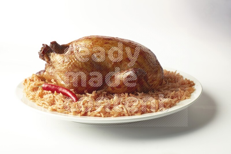 red basmati Rice with  whole roasted chicken on a white rounded plate  direct  on white background