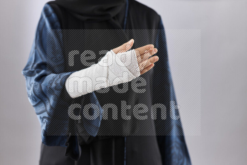 Woman with a bandaged hand and arm sling