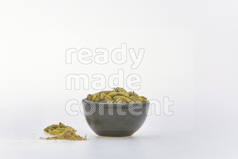 Cardamon in a container on white background