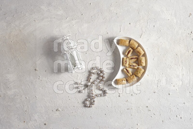 Oriental sweets in a pottery plate with lantern in a light setup