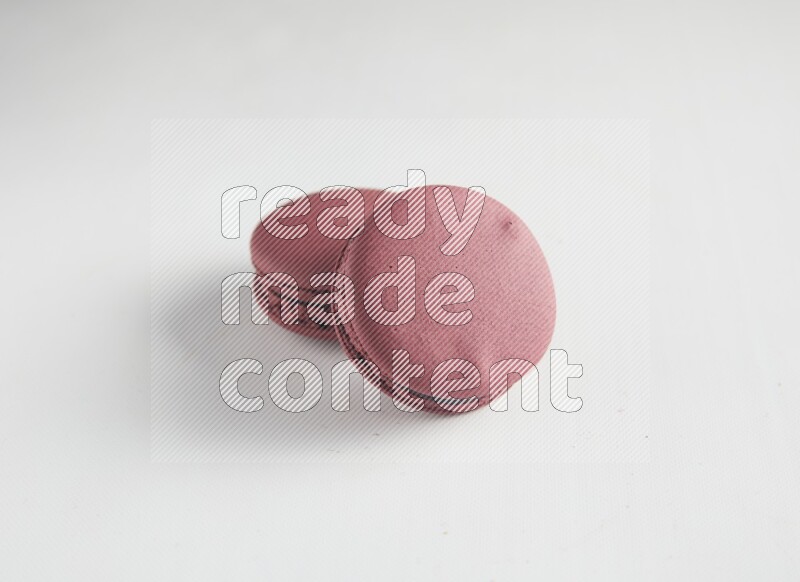 45º Shot of two Red Cherry macarons on white background