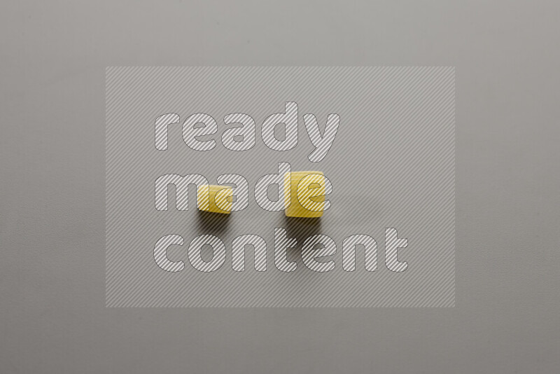 Small rings pasta with other types of pasta on grey background