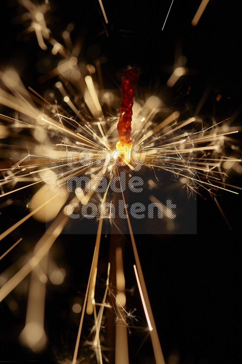 A close-up image of sparkler candle isolated on black background