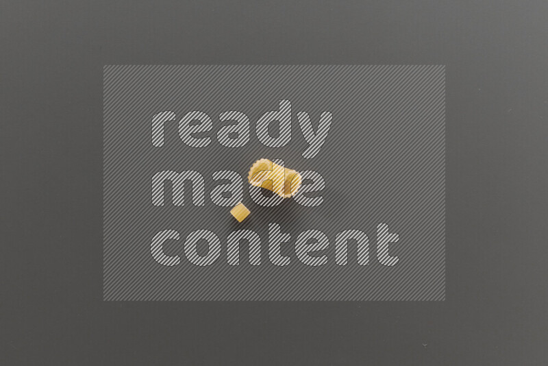 Small rings pasta with other types of pasta on grey background