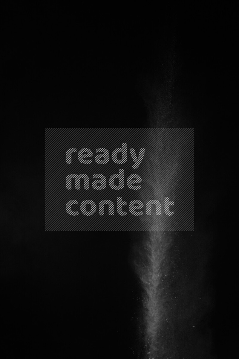 A side view of white powder explosion on black background