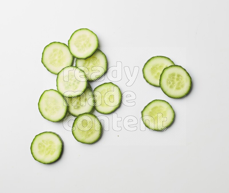 Multiple cucumber slices on white background