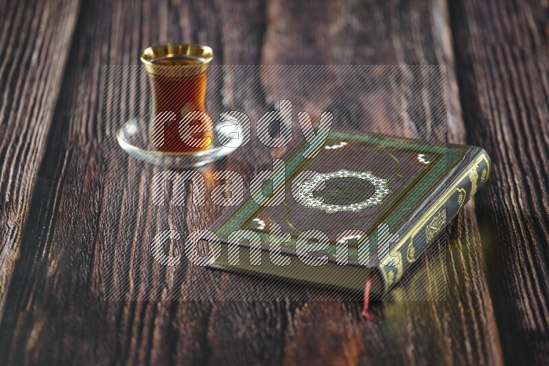 Quran with dates, prayer beads and different drinks all placed on wooden background