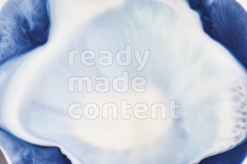 A close-up of abstract swirling patterns in blue and white