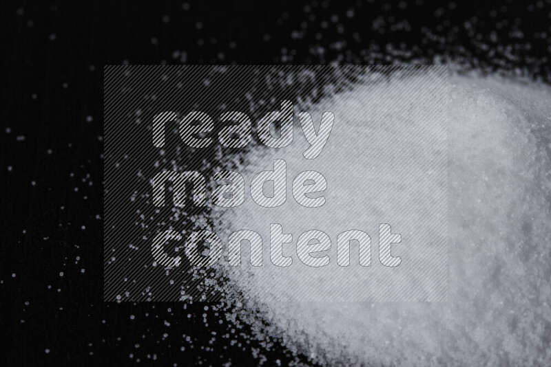 A bunch of fine table salt on black background