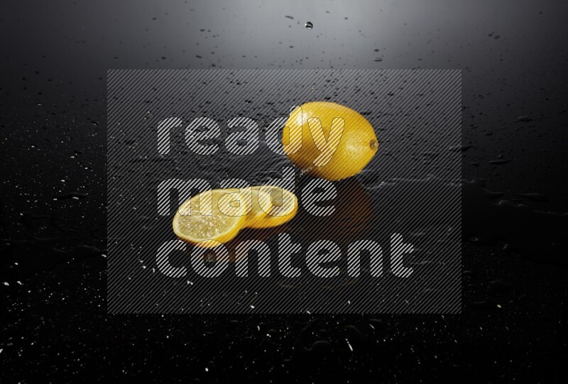 Lemon slices with water drops, and droplets on black background