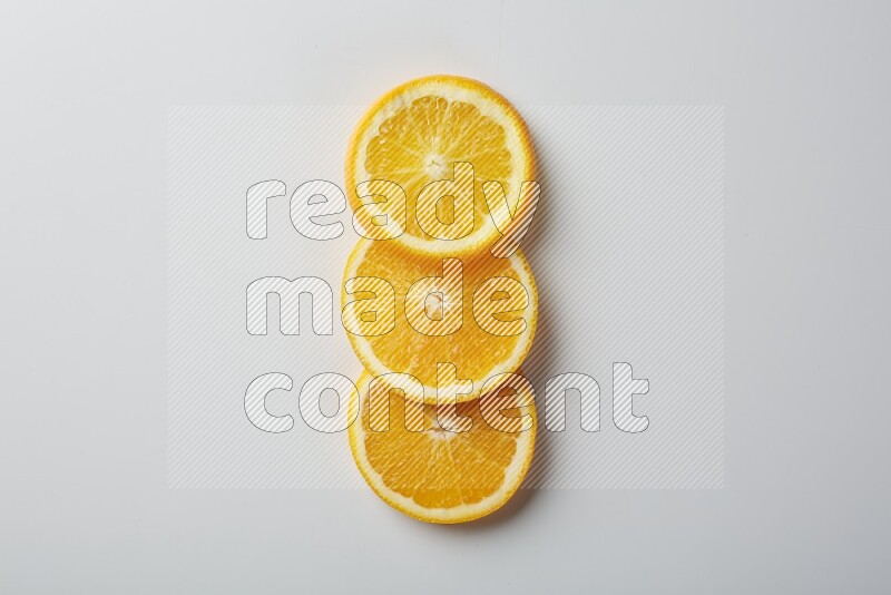 Three orange slices on a white background