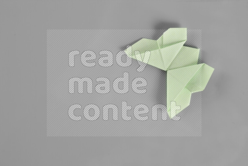 Origami butterfly on grey background