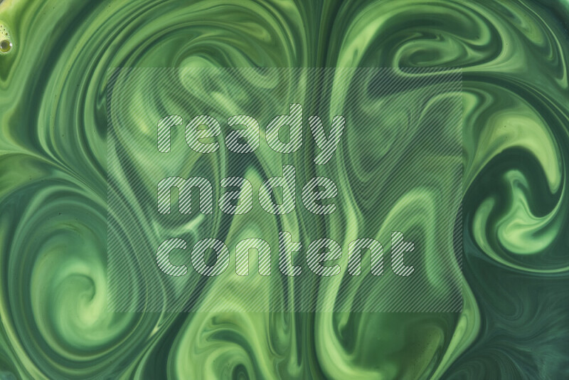 A close-up of abstract swirling patterns in green gradients
