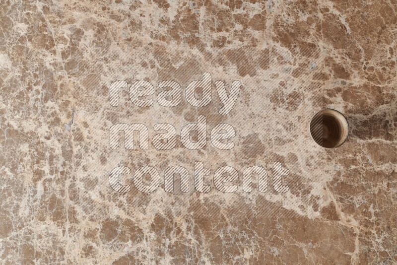 A pottery cup on beige marble background