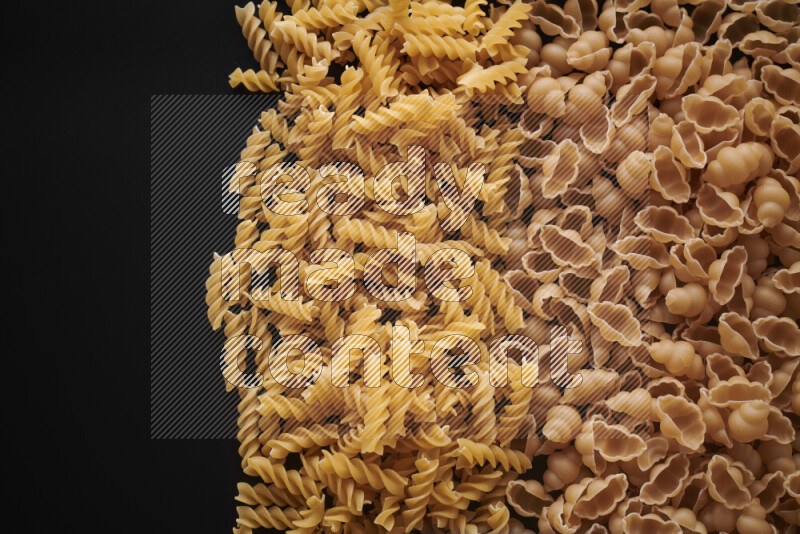 Different pasta types on black background