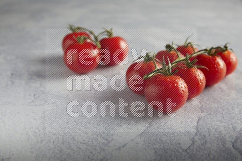 Red cherry tomato vein on a light grey textured background 45 degree