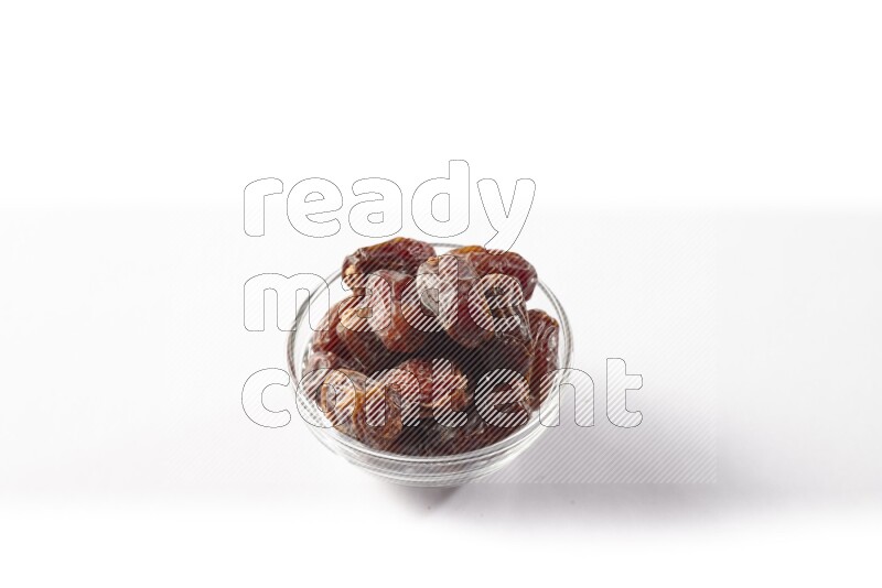 Dates in a glass bowl on white background