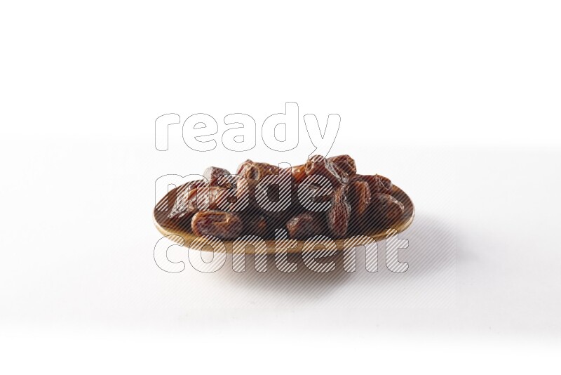 Dates in a wooden plate on white background