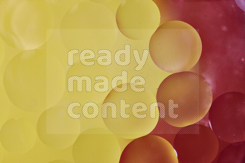 Close-ups of abstract oil bubbles on water surface in shades of red and yellow