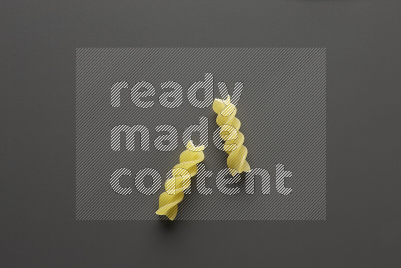 Fusilli pasta on grey background