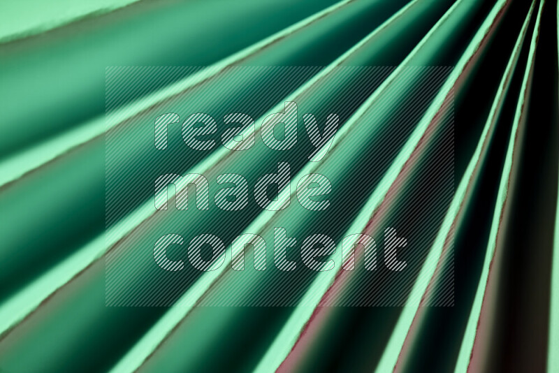 An image presenting an abstract paper pattern of lines in green tones