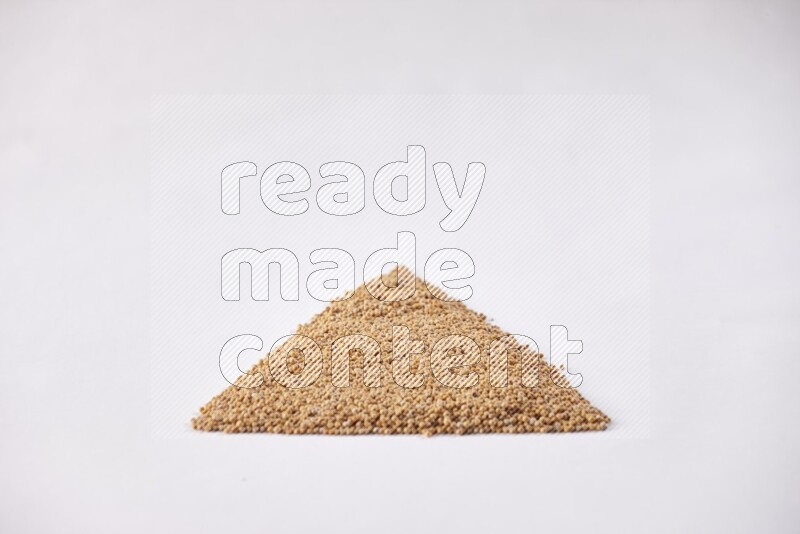 Mustard seeds in a triangle shape on a white flooring