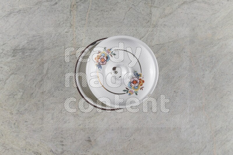 A vintage metal pot on grey marble background