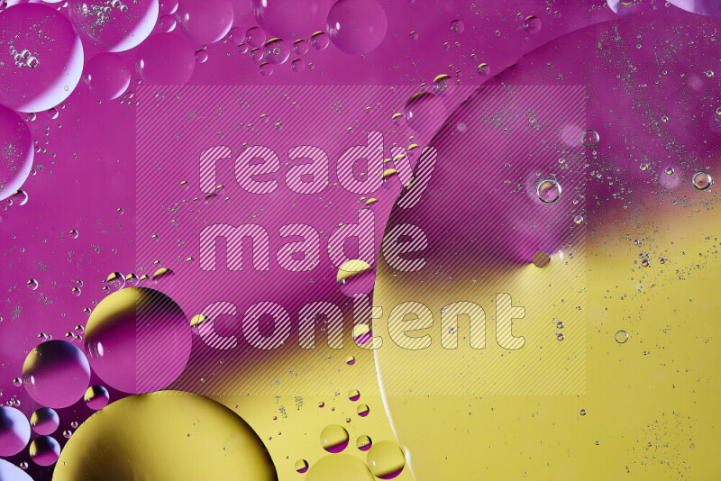 Close-ups of abstract oil bubbles on water surface in shades of yellow and pink