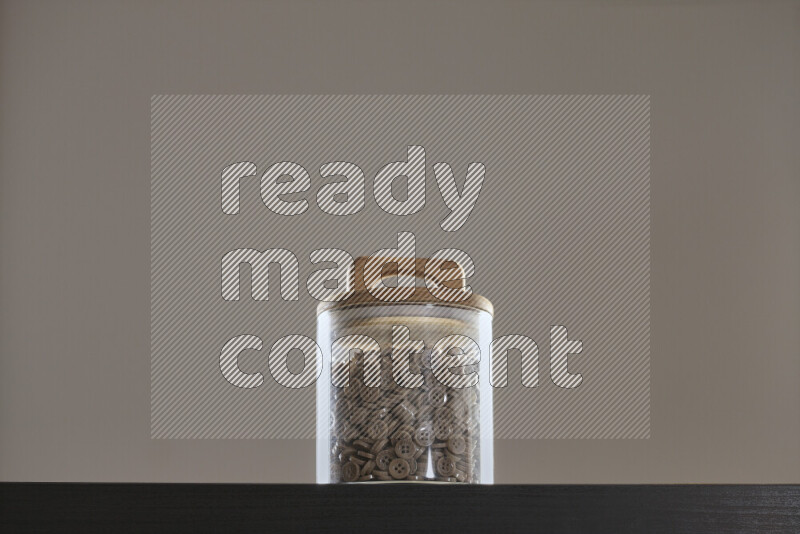 Buttons in a glass jar on black background