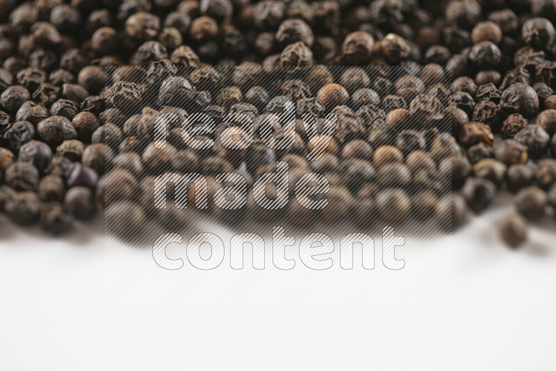 Black pepper beads on white background