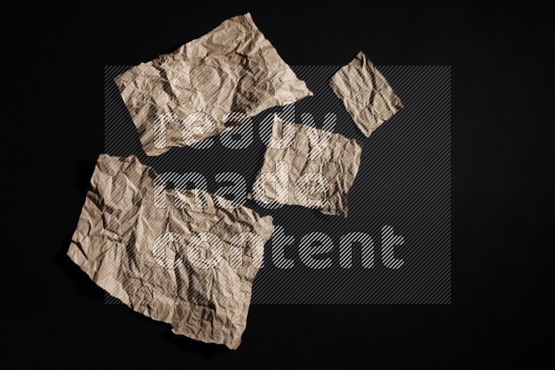 Crumpled craft paper on black background