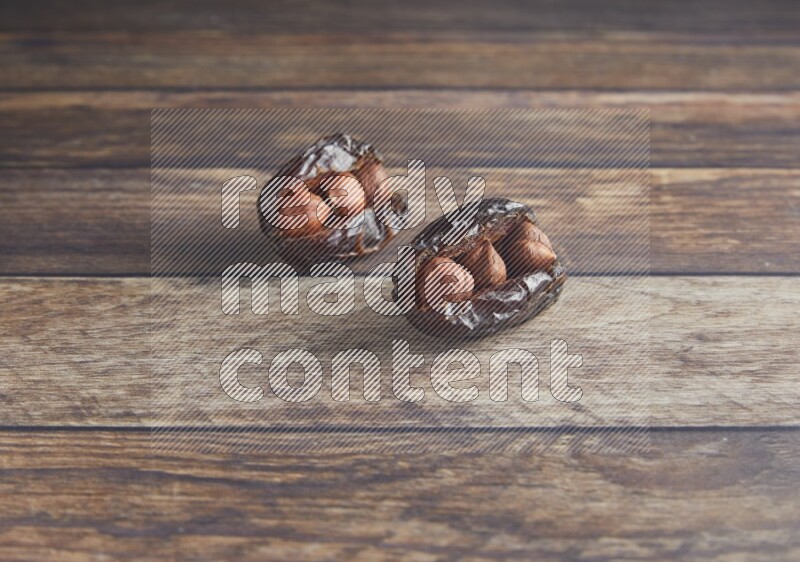 two hazelnut stuffed madjoul date on a wooden background