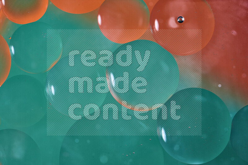 Close-ups of abstract oil bubbles on water surface in shades of green and orange