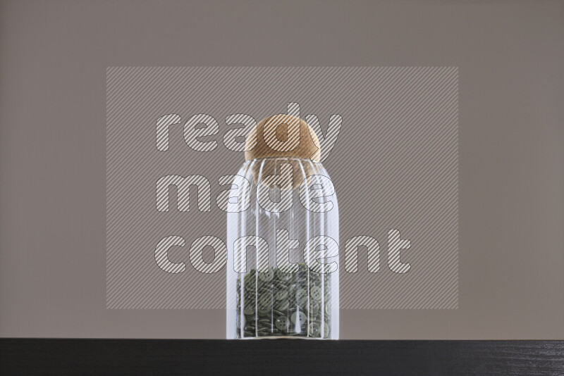 Buttons in a glass jar on black background