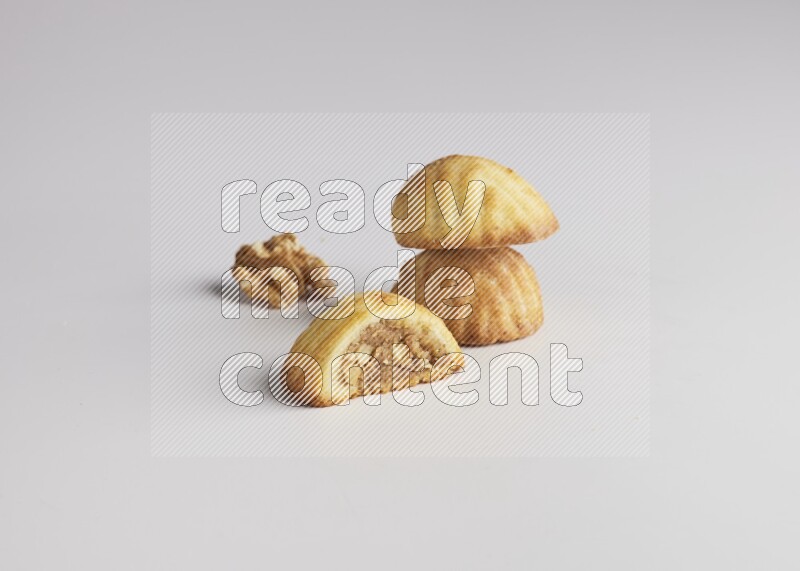 Three Pieces of Maamoul filled with walnut paste  one of them is cut direct on white background