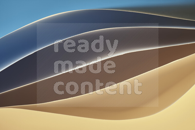 هذه الصورة تعرض تكوين فن الورق التجريدي مع منحنيات ورقية بتدرجات اللون الأزرق والأصفر المكونه بواسطة الضوء الملون