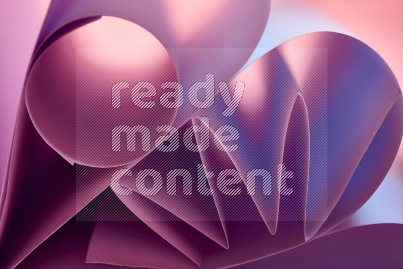 An artistic display of paper folds creating a harmonious blend of geometric shapes, highlighted by soft lighting in purple tones
