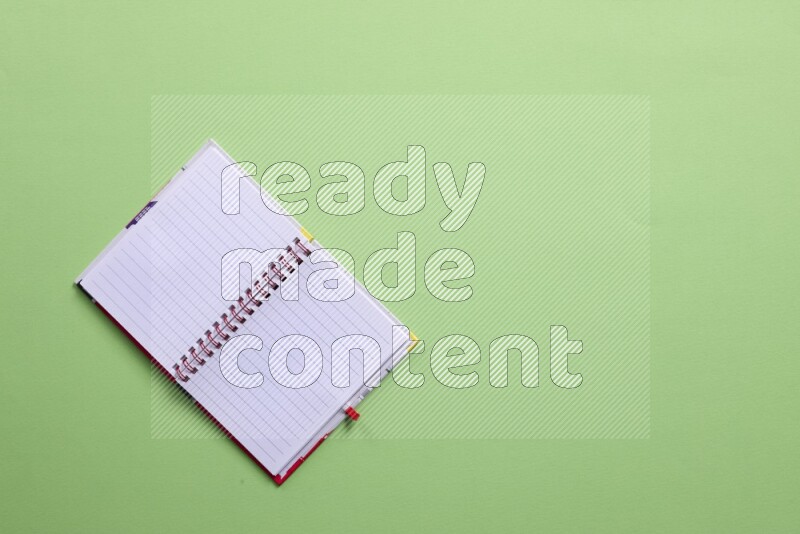 A blank open notebook on green background