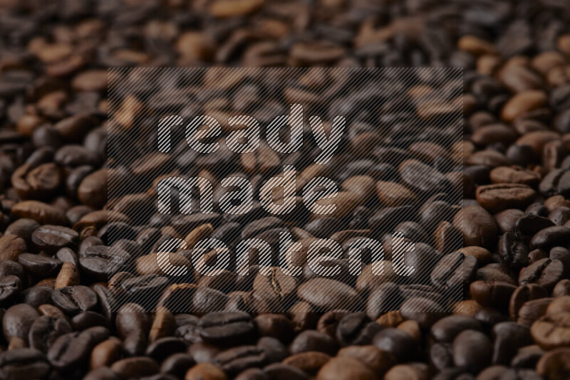 Roasted coffee beans on beige background