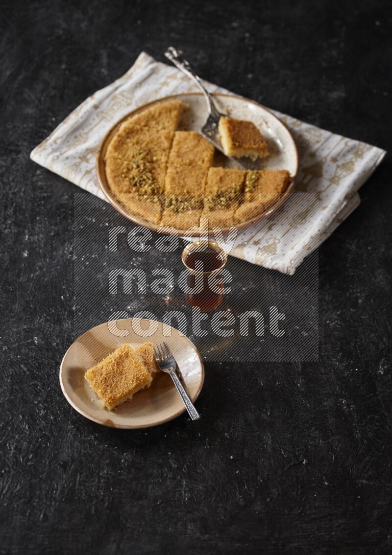 konafa with tea in a dark setup