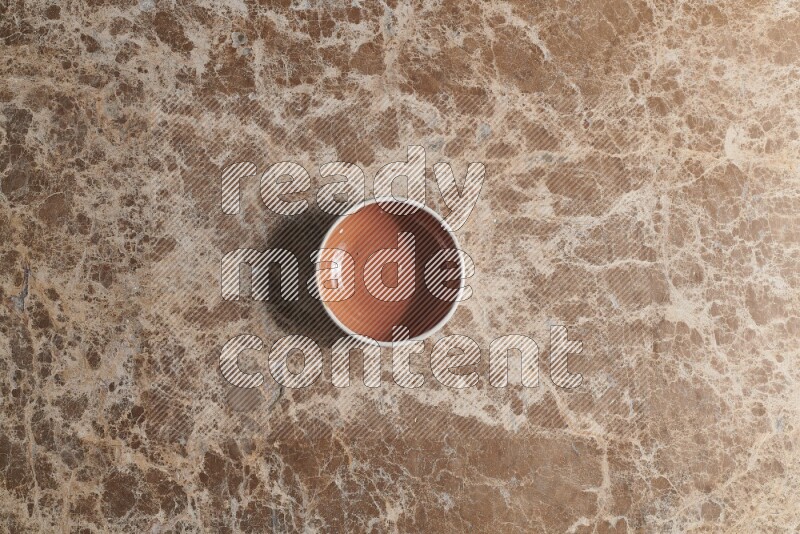 Top View Shot Of A Brown Pottery bowl On beige Marble Flooring